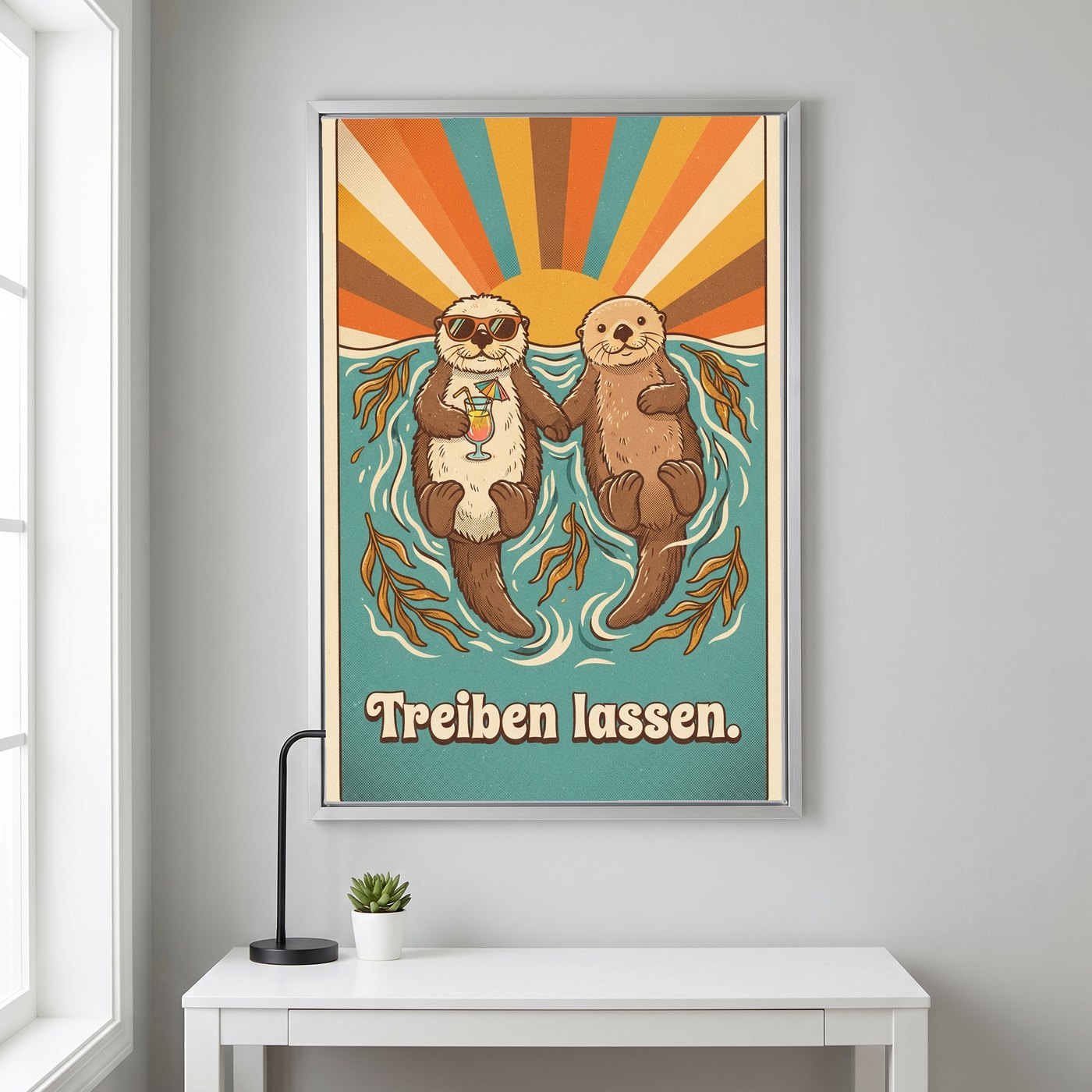 Stoffbild im silbernen Alurahmen mit dem Motiv „Treiben lassen.“ über einem Schreibtisch